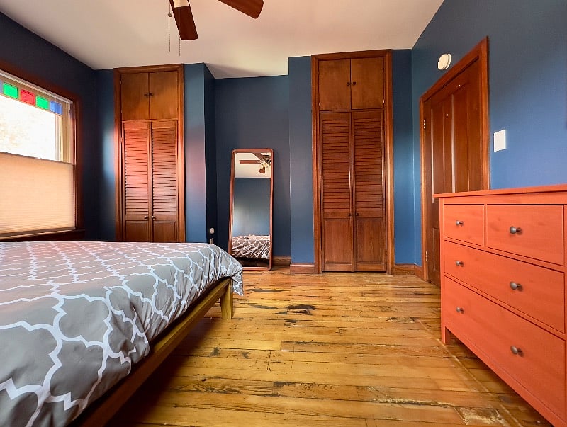Spacious master bedroom with large dresser and two closets