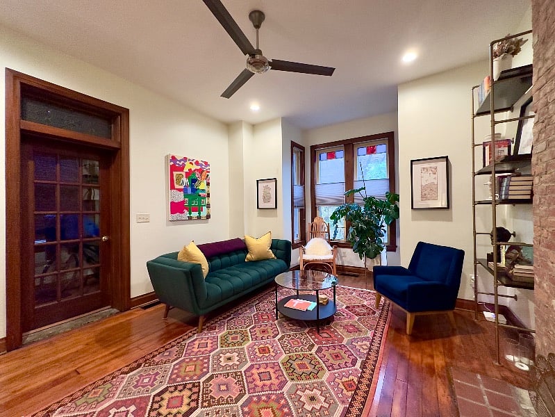 The door on the left goes to a vestibule where there is a coat closet and the front door to the house. Notice the stained glass in the windows.