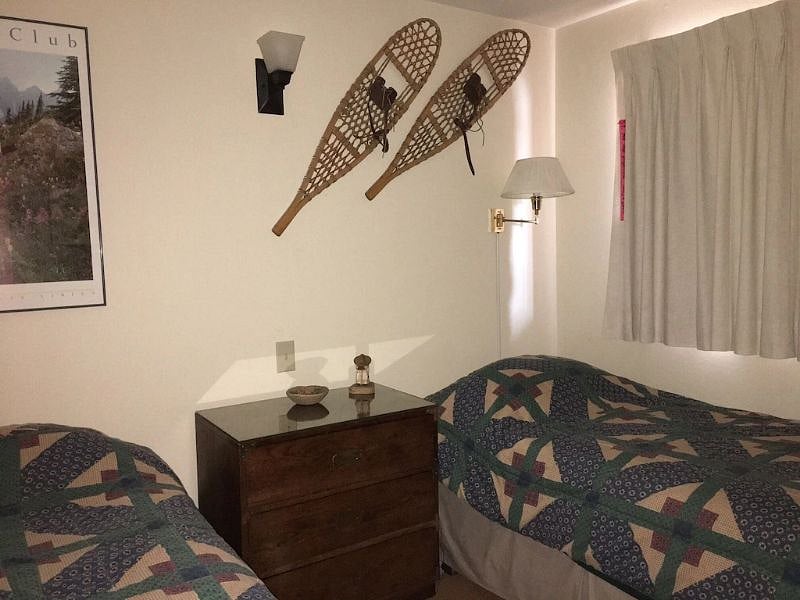 Second bedroom. It has a window that opens but with unremarkable view (parking lot and next condo building slightly up the hill behind). Double closet with sliding doors.