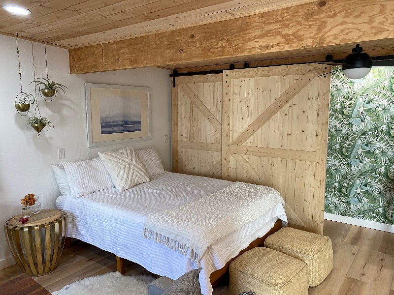Queen Sized Bed. Behind the barn doors is the closet 
