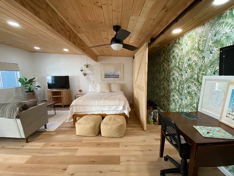 View from the bathroom door looking onto the family room area, bed and desk. The desk folds open more if you want a dining room table for guests. 