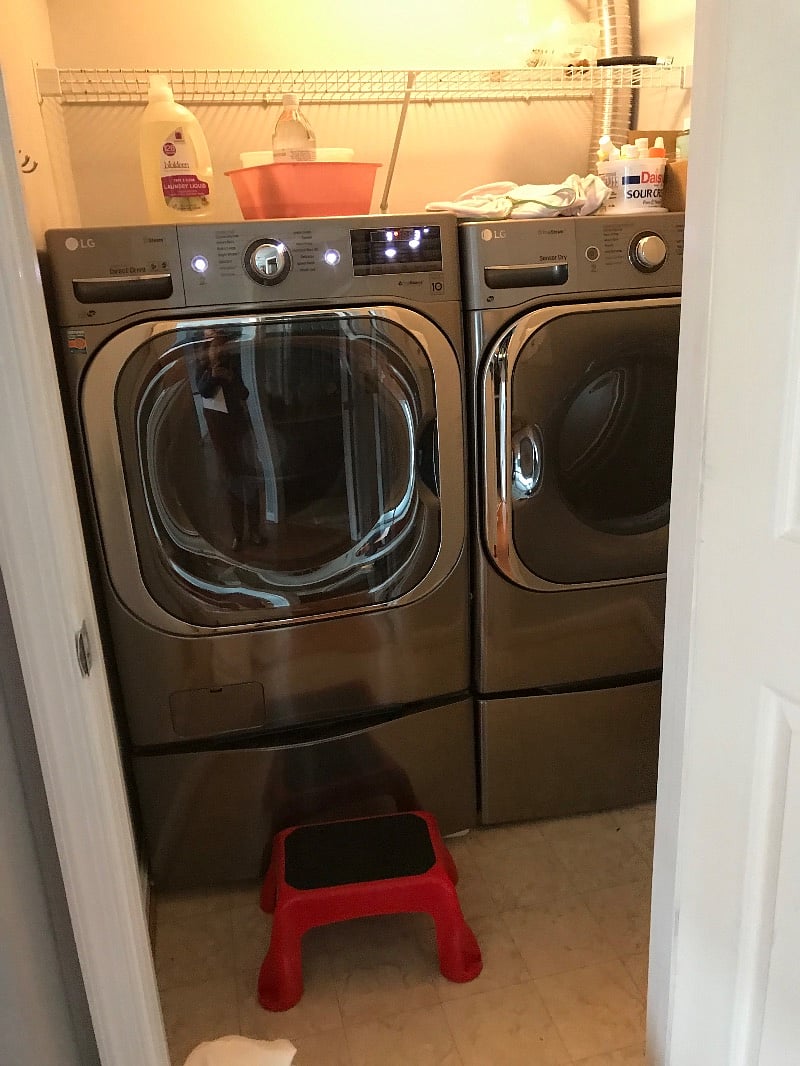Extra large front loading washer/dryer in storage room