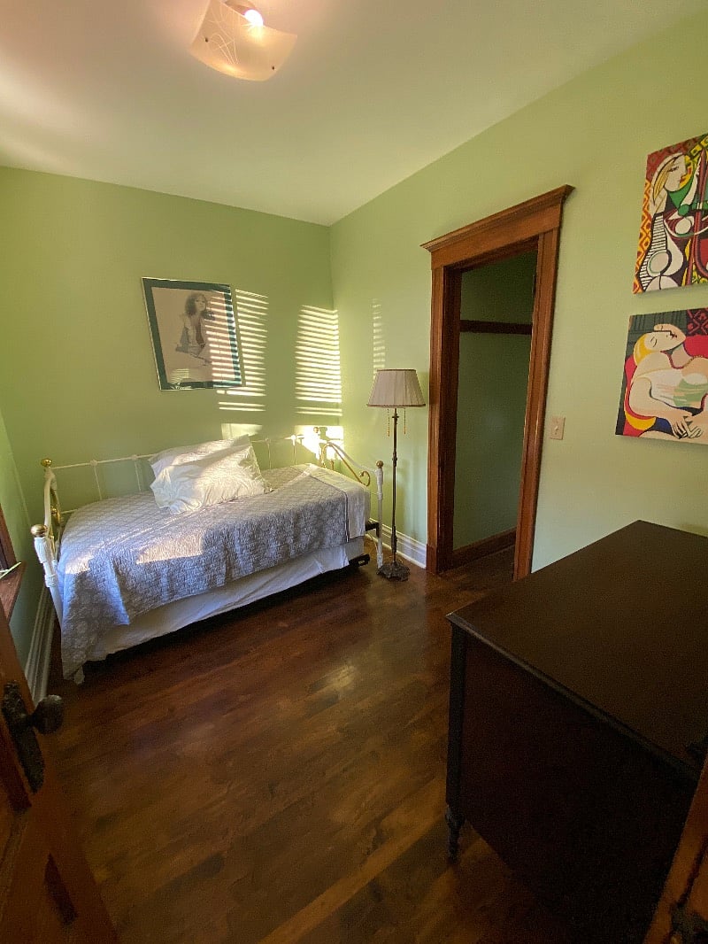 Green bedroom with trundle bed.
