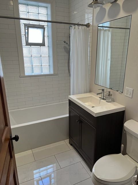 Bathroom: Soaker tub, modern Moen fixtures, and sleek subway tile. 