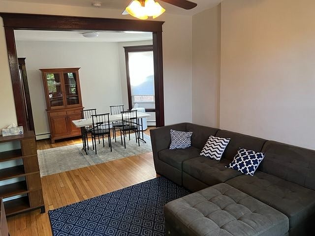 View into dining room: hand crafted Amish wood cabinet, dining table with seating for 4. 