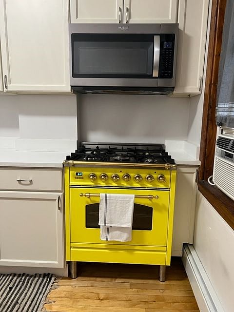 Kitchen: Features an ILVE Italian stove and Whirlpool microwave, fridge, and dishwasher. Storage throughout and includes a coffee bar area. 