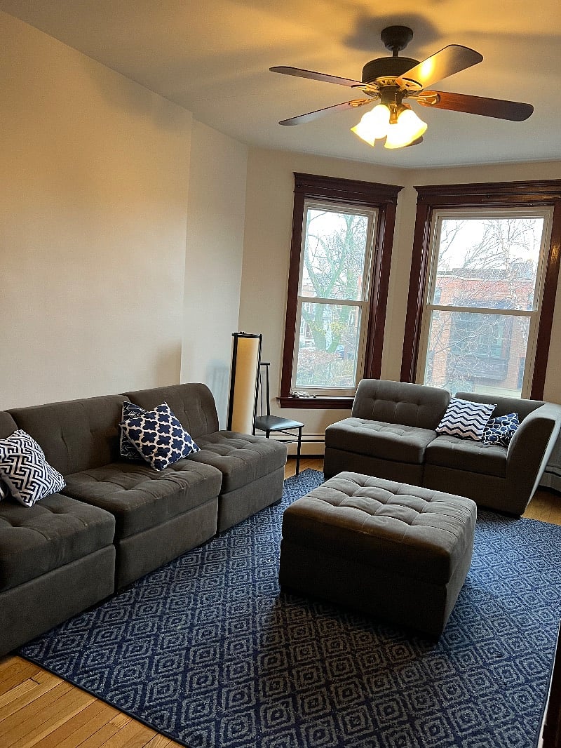 Living room: Features large bay windows and view of the tree lined street. 