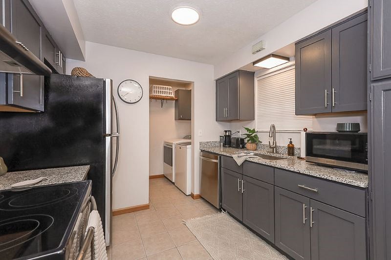 Full kitchen with dishwasher and electric stove
