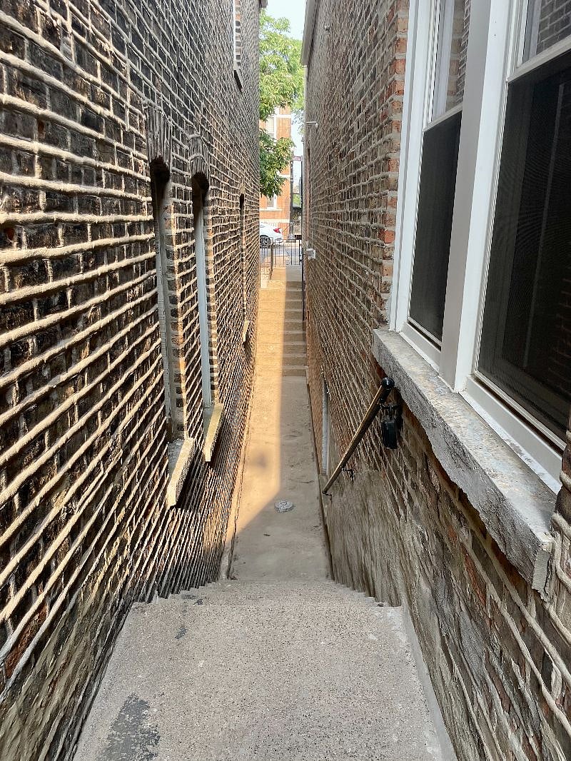 Looking from side entrance towards street in front. Note there are several steps up and down along walkway.