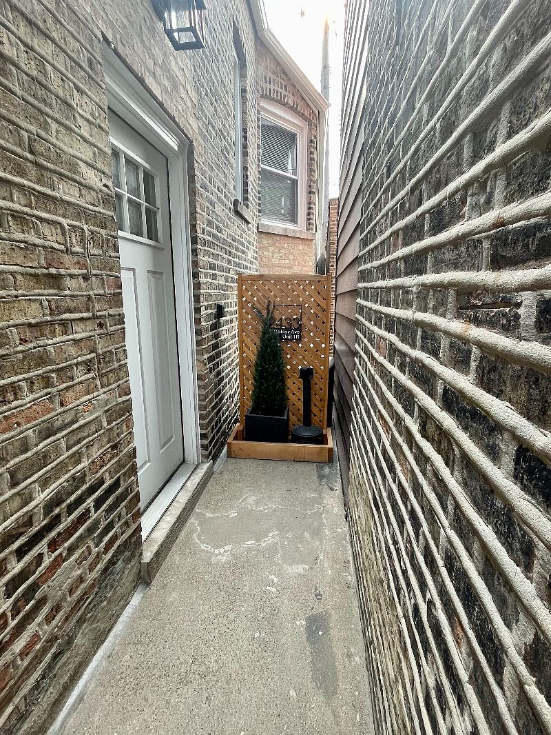 Guest apartment is located in rear of property, accessed through side entrance shown here.