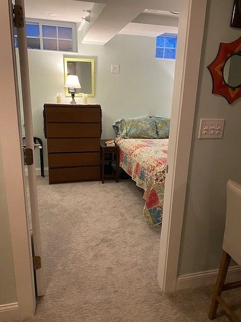 Bedroom dresser and closet on left. Side table has USB port.