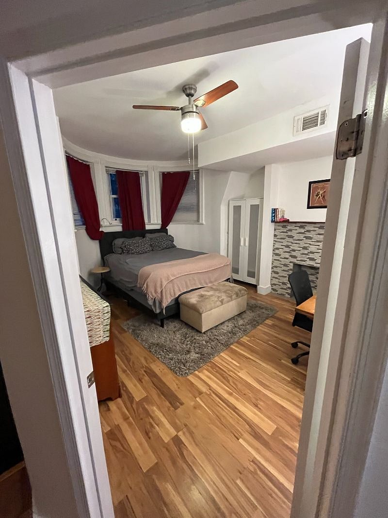 Large bedroom w/ queen-size bed, dresser, closet, armoire, desk/work area, decorative fireplace.  Great afternoon sun from large QWest-facing windows.