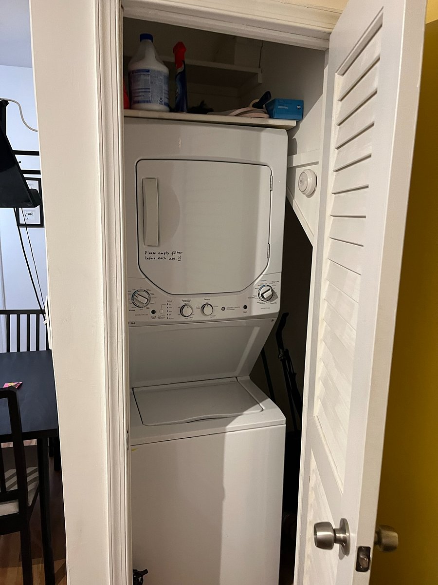 Washer dryer closet with additional storage.