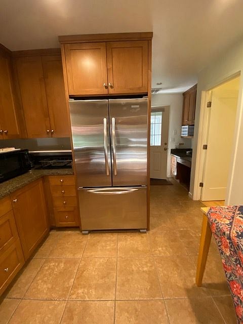 Refrigerator, entry, and closet on the right