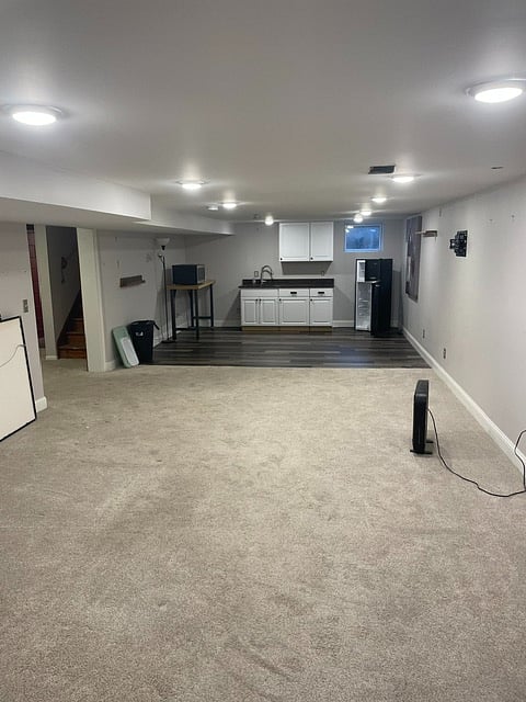 Large lower level with kitchenette , medium size fridge, new carpet and flooring, with walk in closet on other side of area.