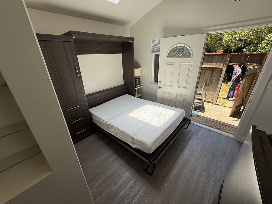 murphy bed opened up. the sitting couch is not in the cottage in this photo.