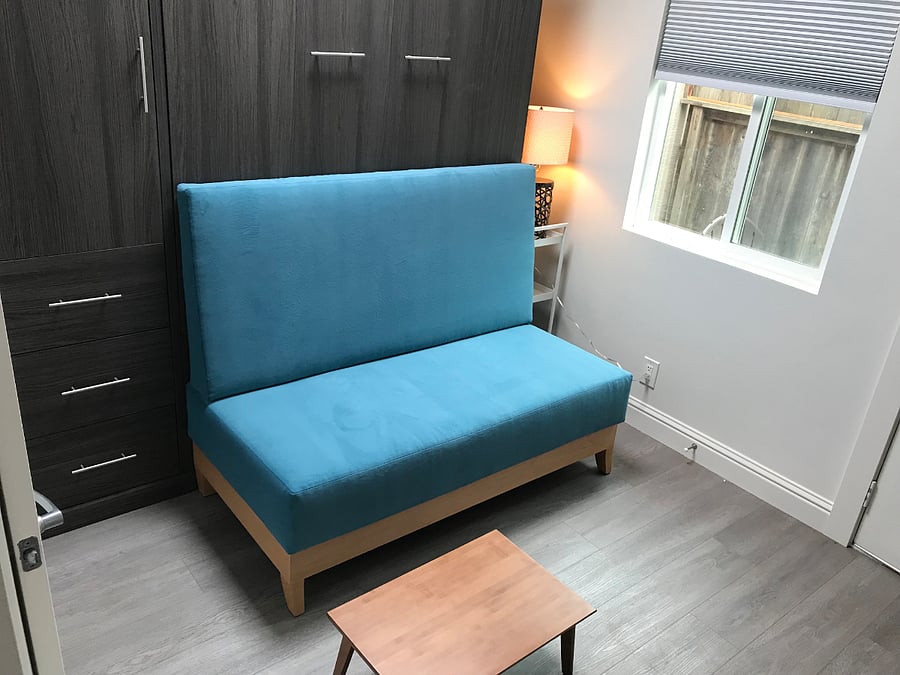 sitting couch which breaks down into 3 pieces to store when the murphy bed is opened up and ready for bed.