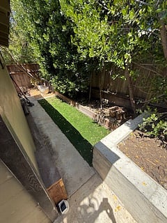 walkway from front door to patio in rear has grass area.
