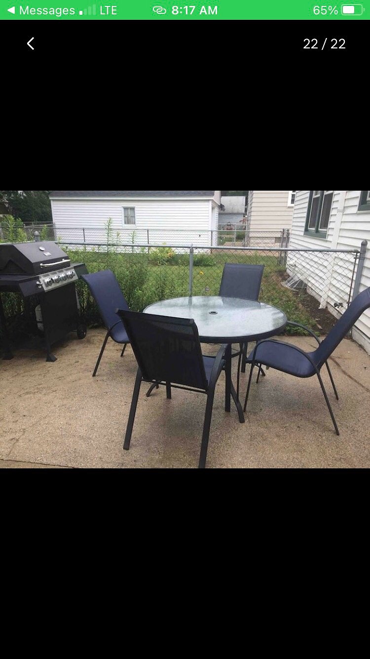 Outdoor area with small patio and gas. Grill.  Fenced in yard.