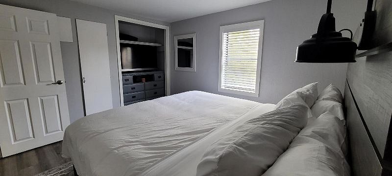 Bedroom 1 with super comfy new mattress! TV with Roku. Convenient reading lights.