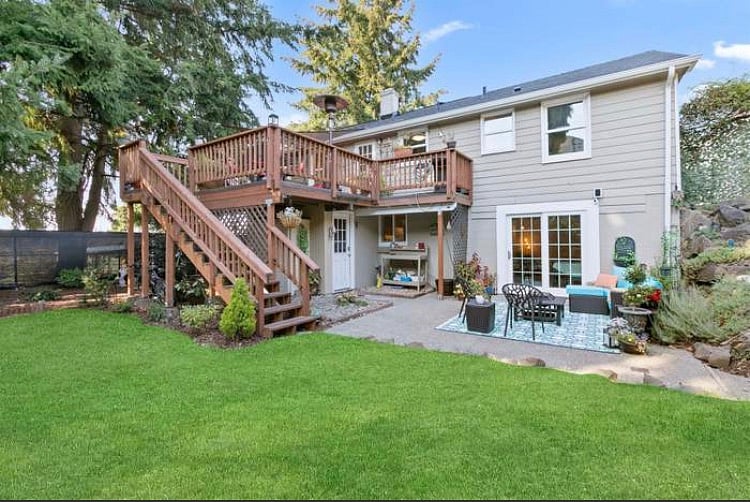 Full backyard view - upper deck is for upstairs resident, lower patio is yours. You can see white door to laundry room below upper deck in this photo.