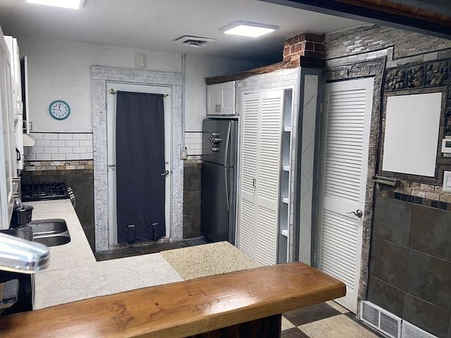 HUGE kitchen with granite counters and tile floor, breakfast bar, new stainless appliances, and all the cooking amenities you might want, coffee maker, microwave, toaster oven, blender, pot pans, George Foreman and plenty of cleaning supplies under the sink.