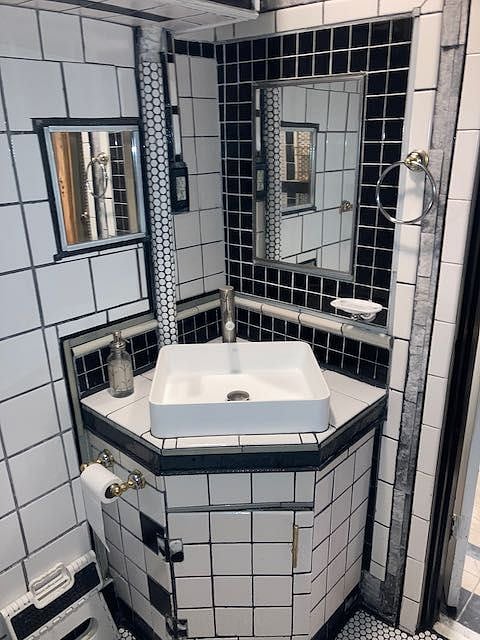 Custom maid vanity with storage and vessel sink.