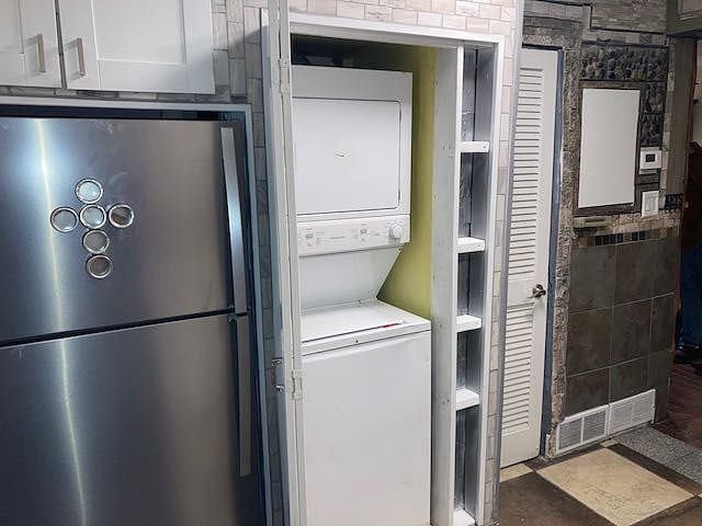Tucked away stackable gas washer and dryer.