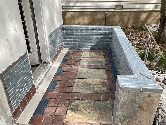 Small tiled patio back entrance.