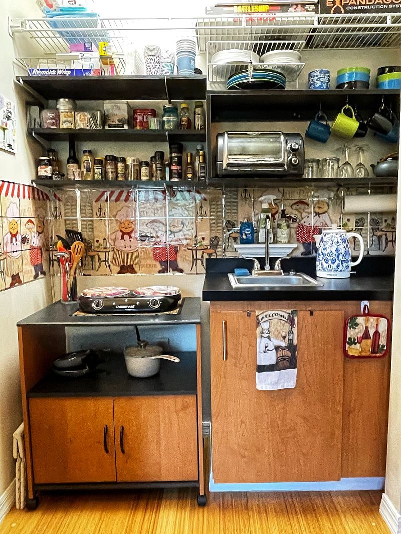 Well-stocked MINI-KITCHEN includes stove top, toaster oven, microwave, fridge, instant pot, Keurig coffee maker, water kettle, cooking and serving utensils, spices and condiments.
