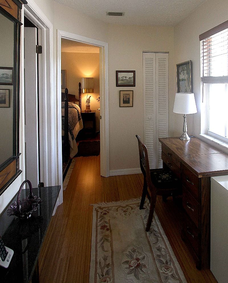 Hallway hosts a workstation with desk, wifi and device plug-ins. Linen closet supplied with extra towels and linens.