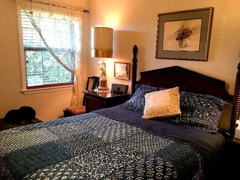 BEDROOM features Old World charm, with a queen-sized bed, antiques, and ample storage for a long-term stay.