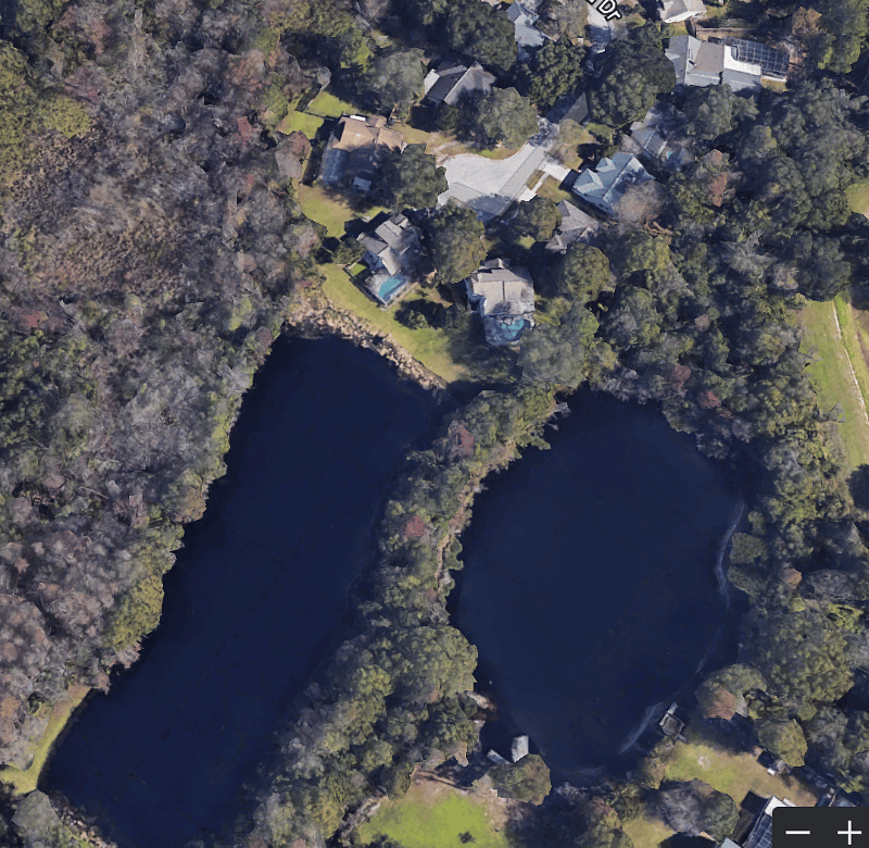 The property (pictured atop the water) is located on a quiet cul-de-sac and nestled adjacent to a spring fed fishing pond and nature preserve.