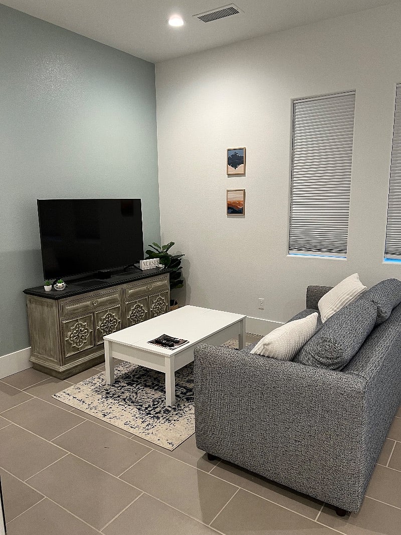 Coffee table adjusts to use as laptop station or for a meal area. Comfy throw blankets are inside.