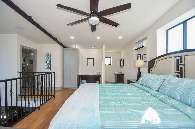 Spacious bedroom with a desk, chair, lounging area