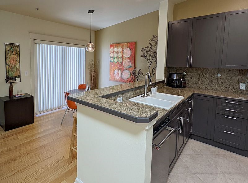 Open kitchen and dining room with sliding doors leading to a covered deck