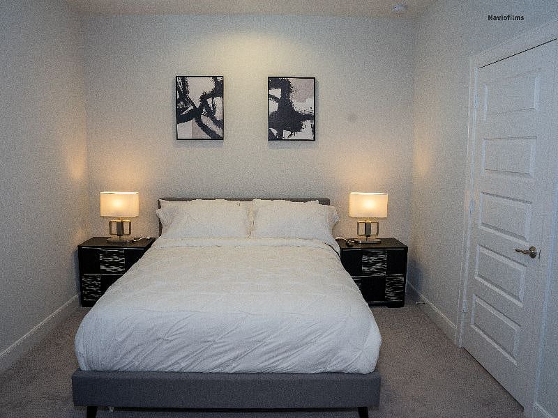 Third floor. Secondary bedroom. Fully furnished with queen bed, tv, nightstands, desk and chair. Individual closet space. 