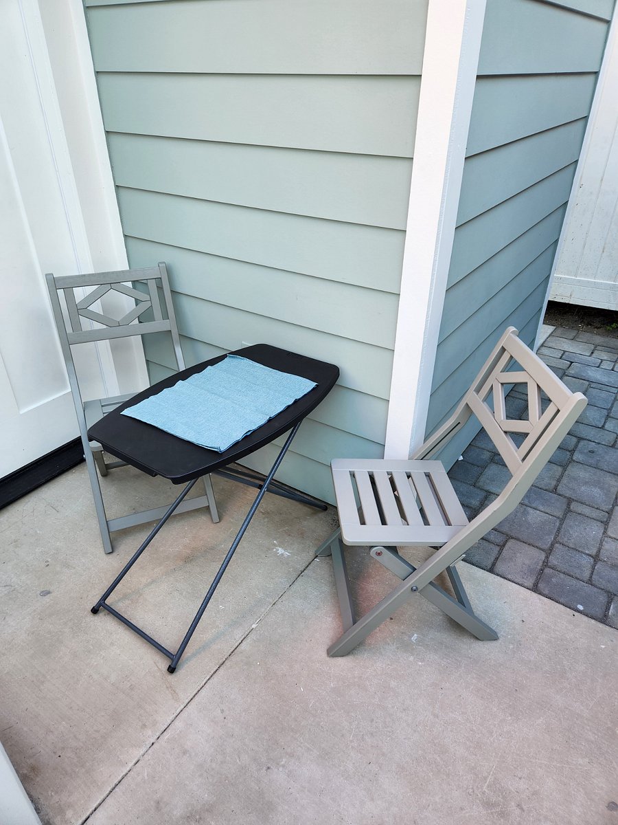 Outdoor dining with seat cushions and umbrella when needed.