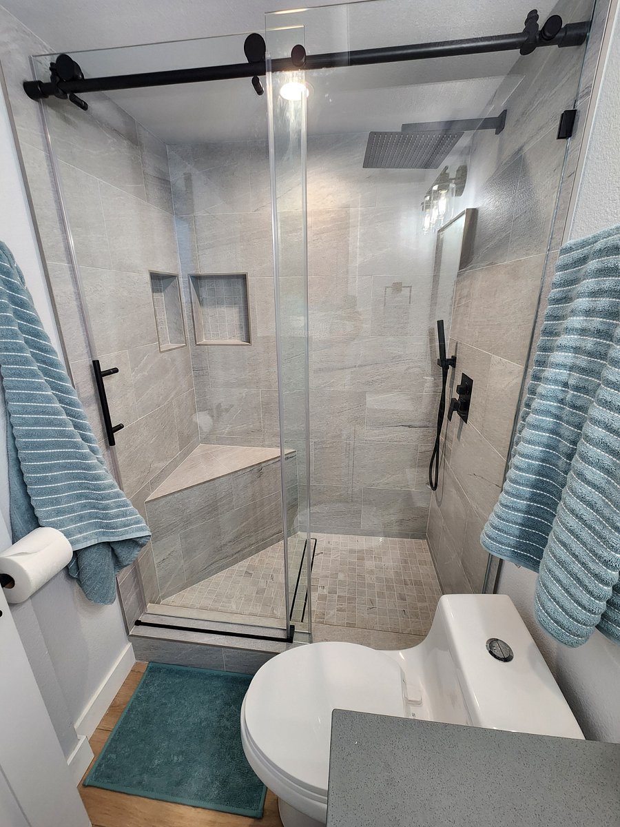 Gorgeous walk-in shower with bench seat, rain shower head and separate shower wand.