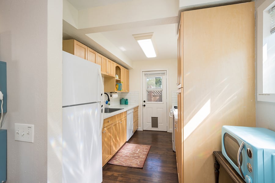 Large fridge and retro-vibes microwave over. Well-stocked with toaster, air fryer, and all the gadgets you need to really cook!