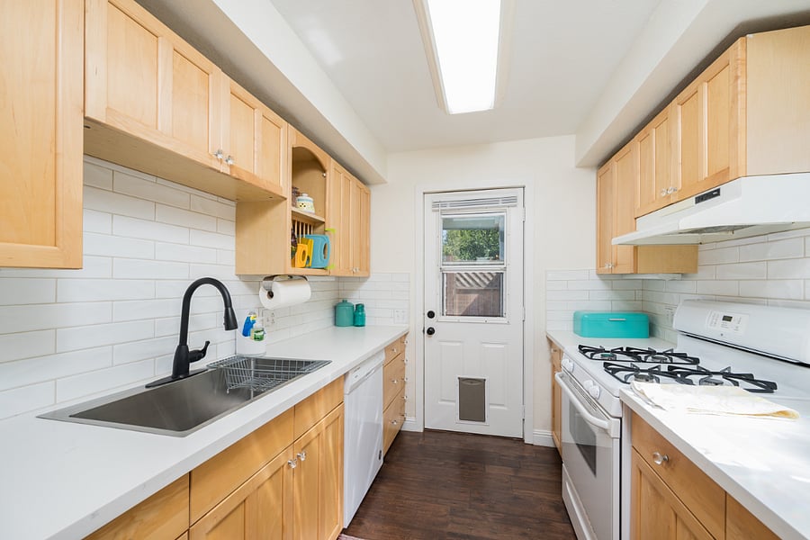 Spacious quartz countertops, clean crisp subway tile back splashes and a newish dishwasher!