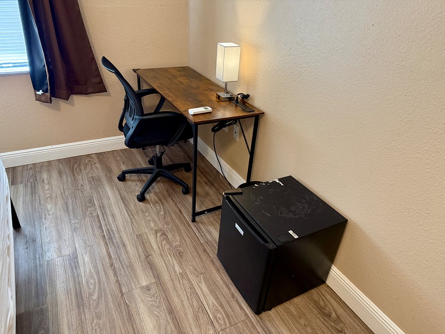 Office desk and chair and your own mini fridge