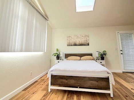 Main bedroom queen bed and skylight.