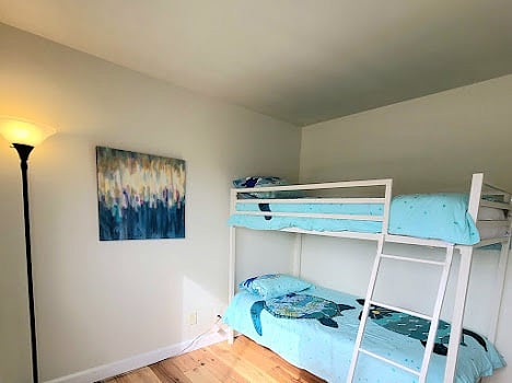 Second floor bedroom with twin bunk beds and full closet