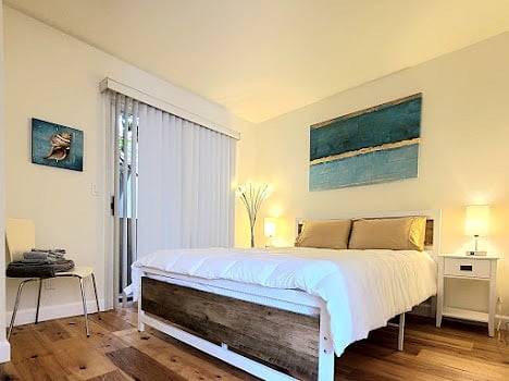 Second floor bedroom with queen size bed, full closet, and private balcony.