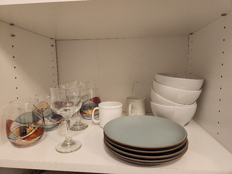 Downstairs I provide basic kitchen items such as plates, glasses, bowls, silverware, strainers, dish rack, cooking utensils, cutting boards, etc.