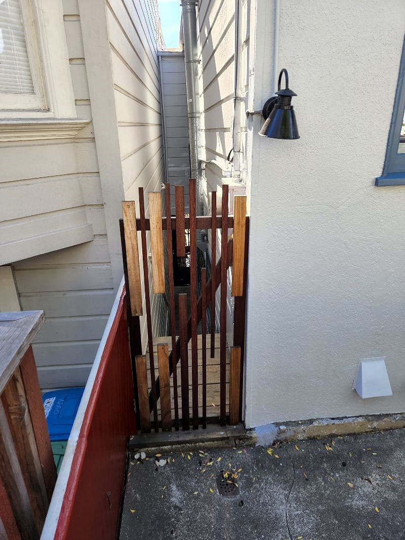 Downstairs side entrance. Down the stairs is a locked gate and enclosed protected area at downstairs front door. Keybox at entry.