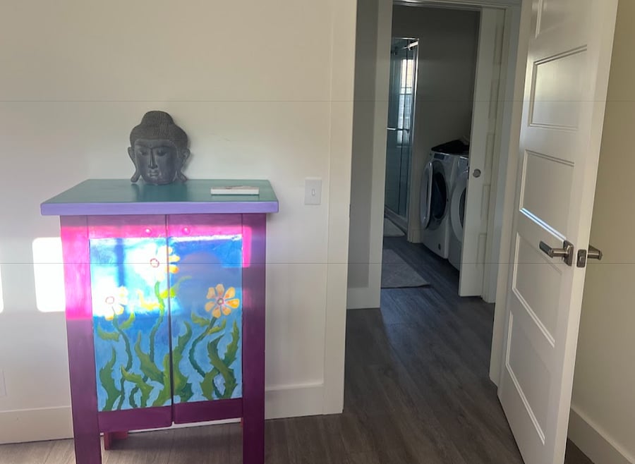 Master bedroom with view of bathroom across hall