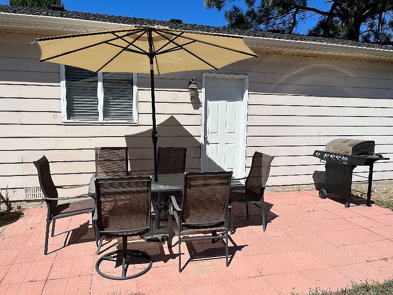 Backyard has a patio with table and umbrella. Gas grill also!