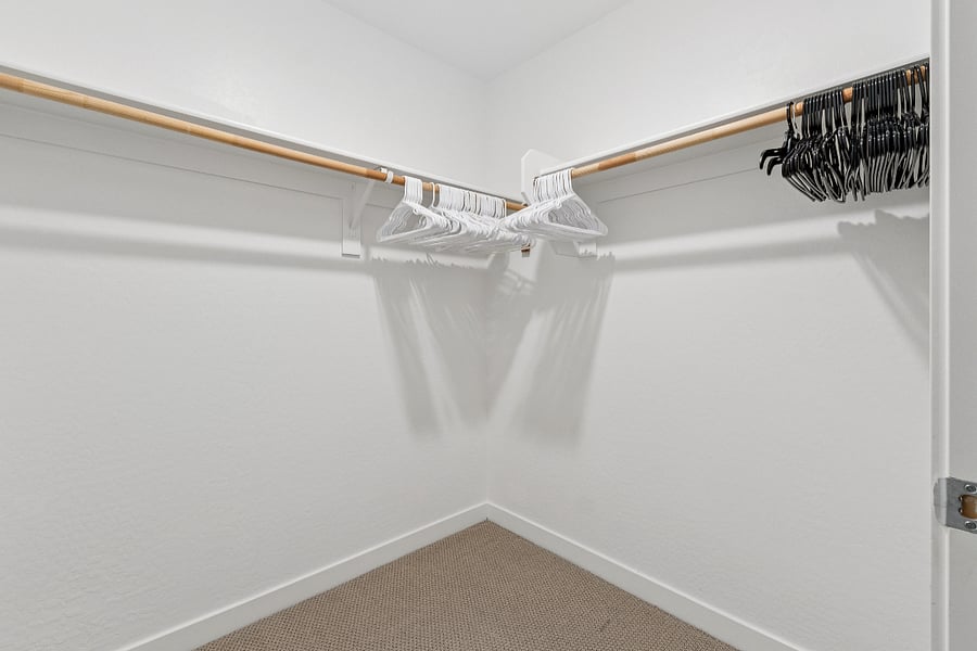 Primary bedroom walk-in closet